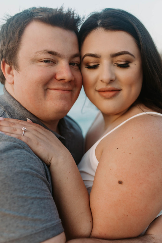 couple posing on the beach for their engagement photos in big sur california