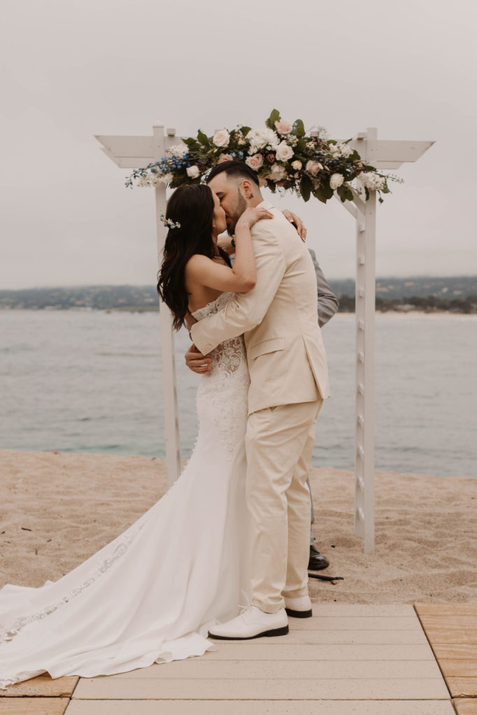 bride and groom share their first kiss