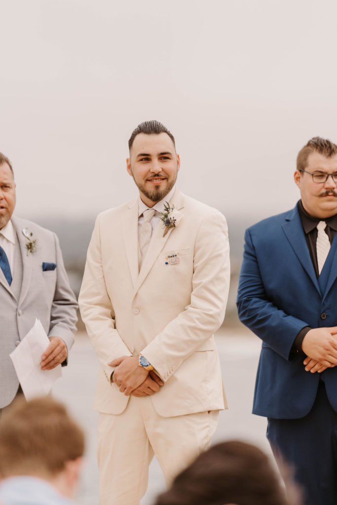 groom posing at the altar