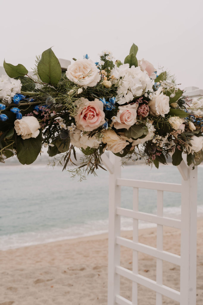 flowers on the wedding arch at Romantic Beach Wedding in Carmel, CA