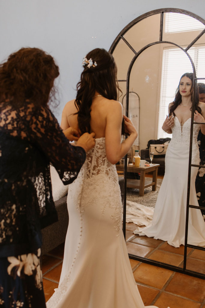 bride getting ready in the mirror at Romantic Beach Wedding in Carmel, CA