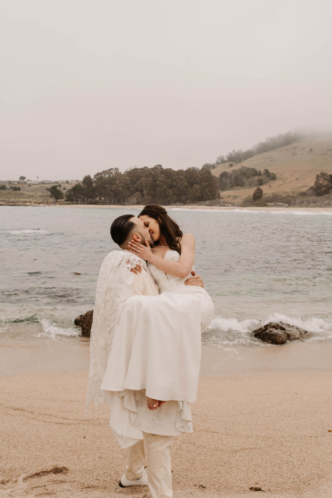 bride and groom posing on the beach