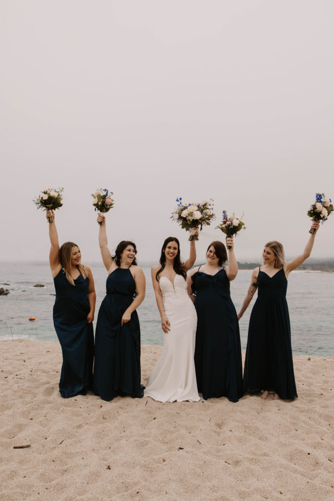 bridesmaids posing on the beach at Romantic Beach Wedding in Carmel, CA