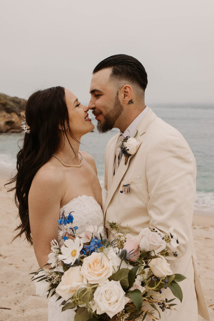 bride and groom posing on the beach