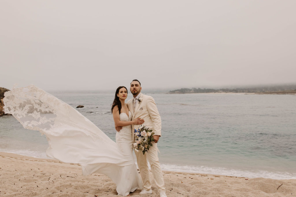 bride and groom posing on the beach