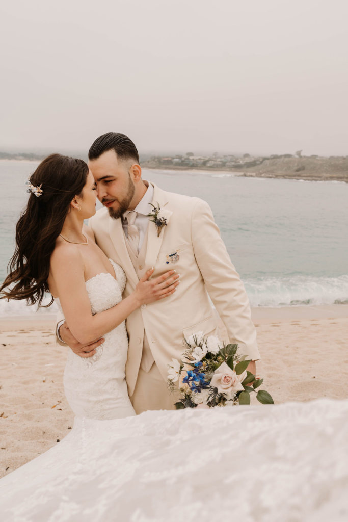 bride and groom posing on the beach