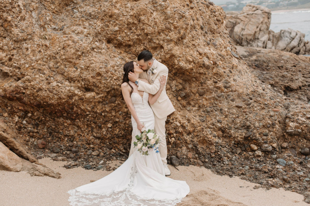 bride and groom posing on the beach