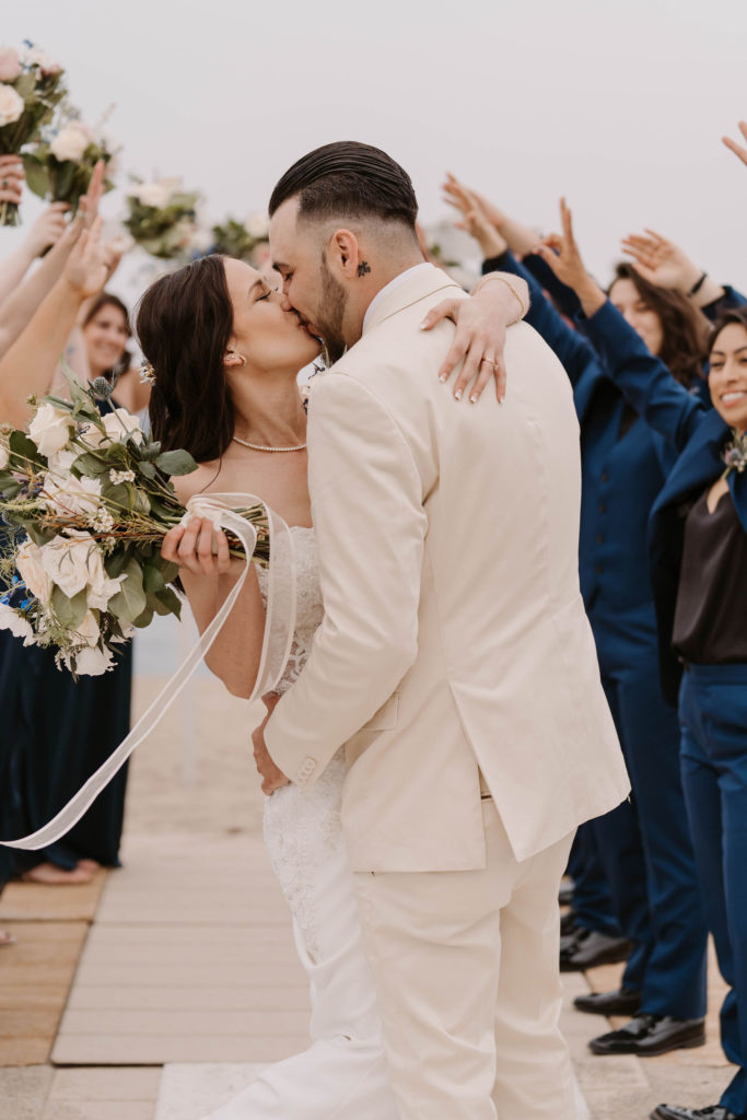 bride and groom celebrating and kissing