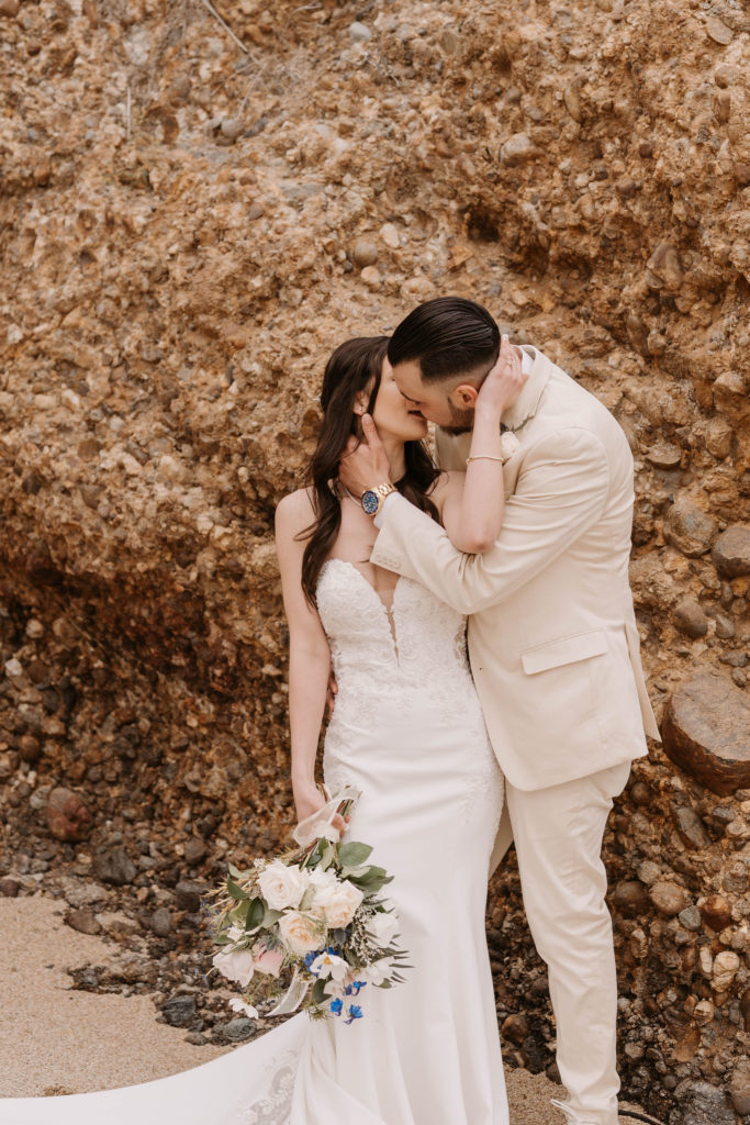 bride and groom posing on the beach