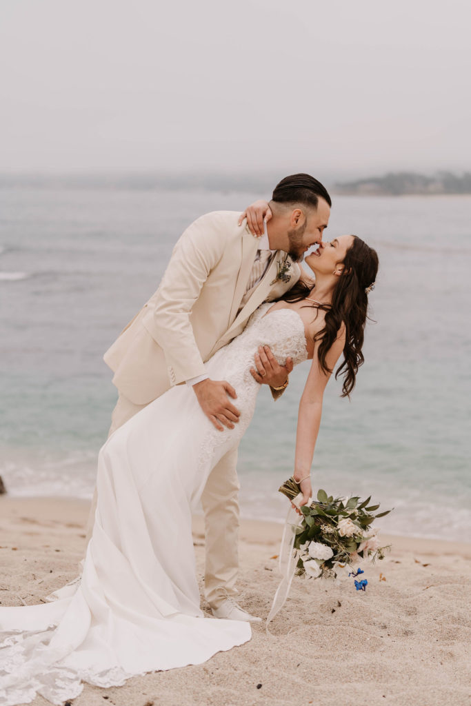 bride and groom posing on the beach at Romantic Beach Wedding in Carmel, CA