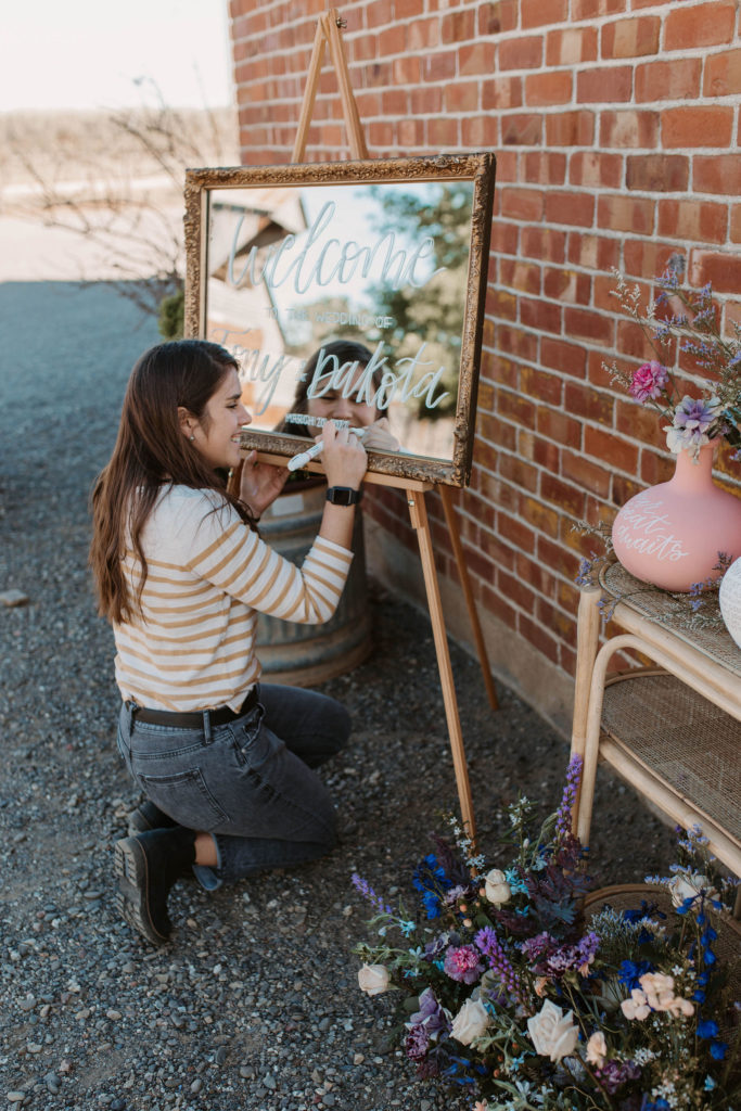 Wedding vendor setting up wedding welcome sign