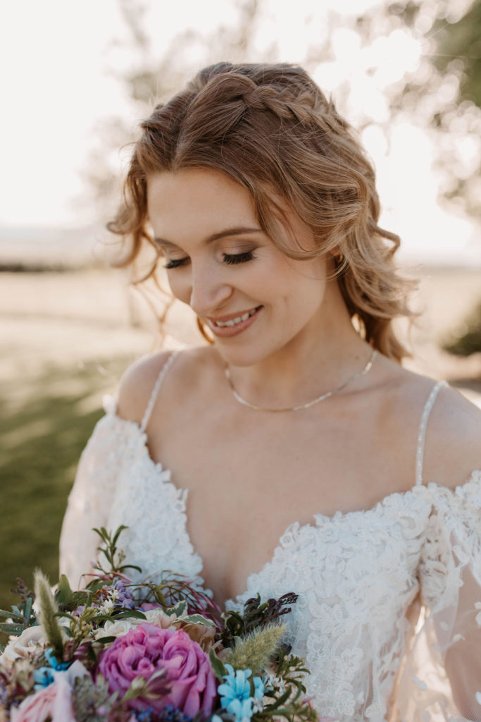 Bride posing with wedding flowers in Woodland California