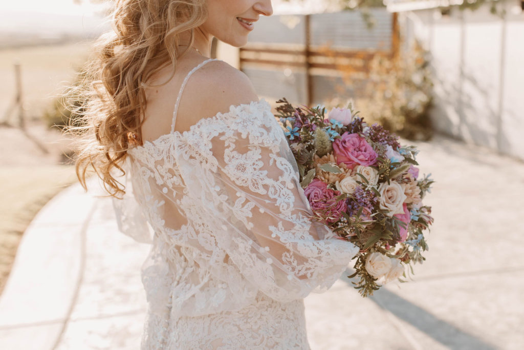 Bride holding spring wedding flower bouquet 