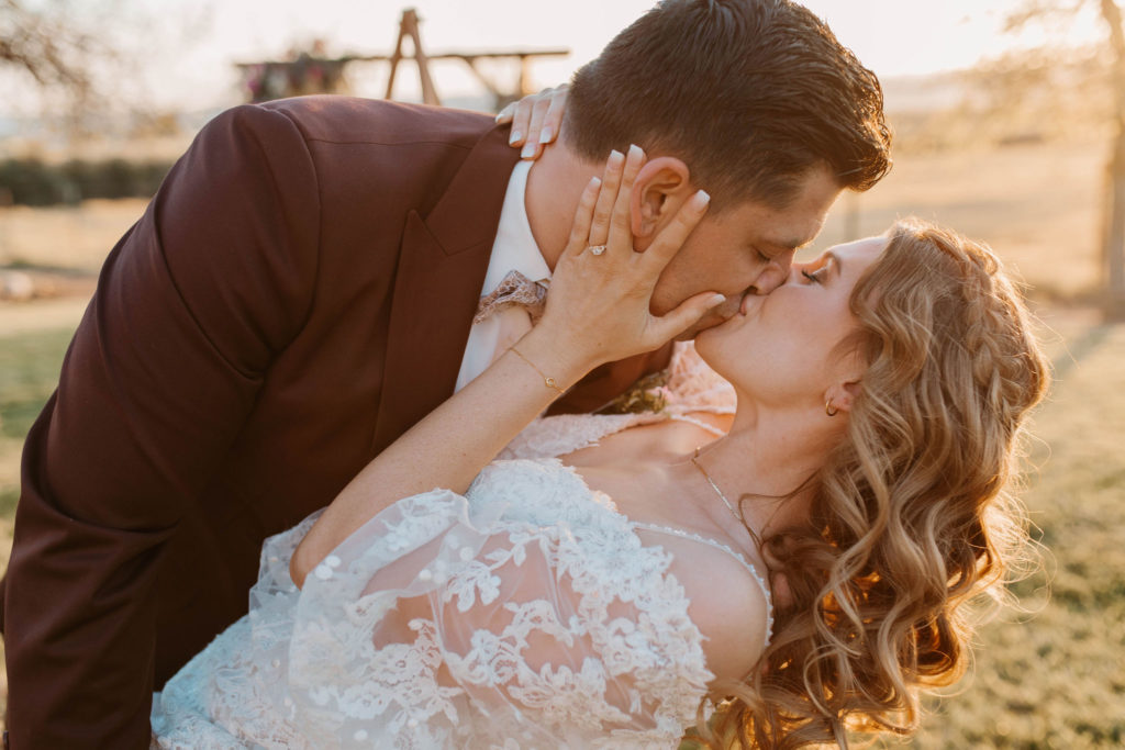 Bride and groom kissing during wedding in Woodland California 