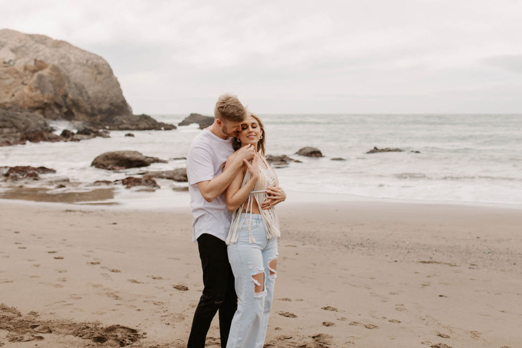 Couple posing for photo shoot couple ideas and prompts on beach in San Francisco California