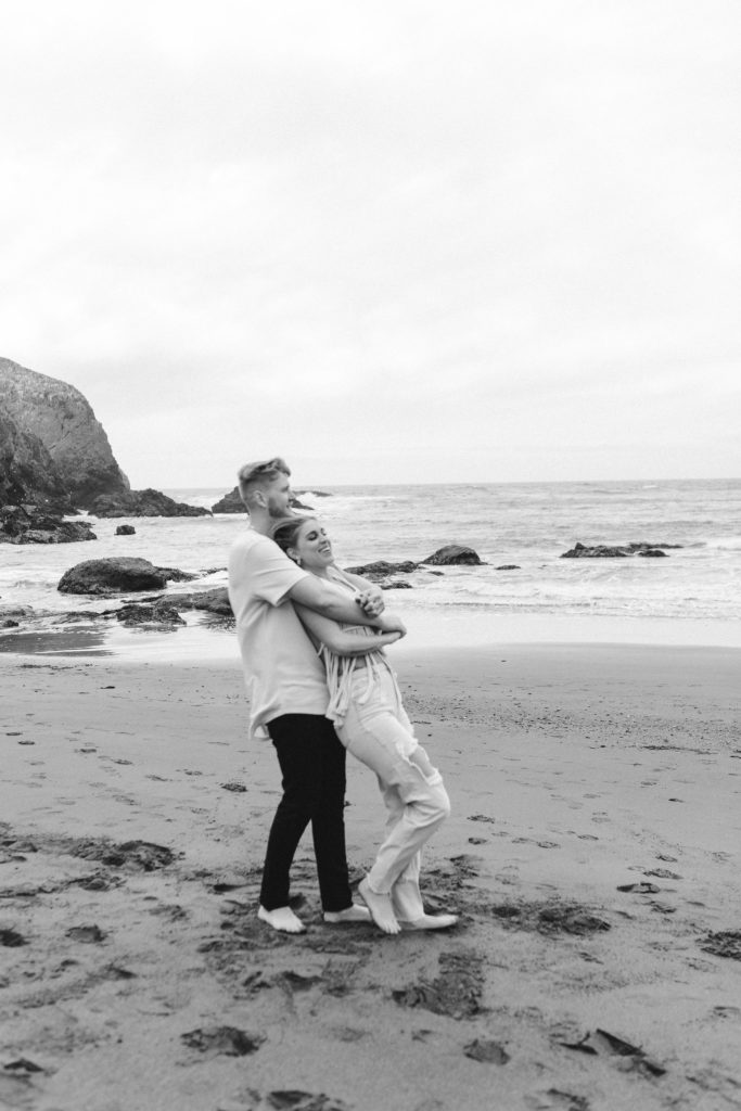 Couple posing for photo shoot couple ideas and prompts on beach in San Francisco California