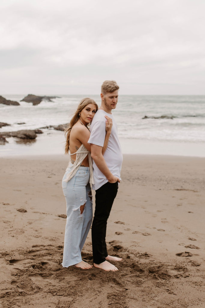 Couple posing for photo shoot couple ideas and prompts on beach in San Francisco California