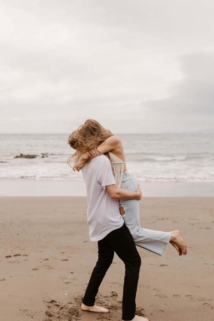 Couple posing for photo shoot couple ideas and prompts on beach in San Francisco California