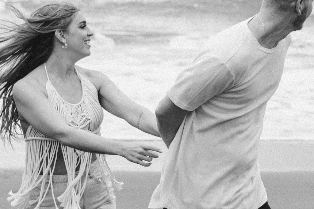 Couple posing for photo shoot couple ideas and prompts on beach in San Francisco California