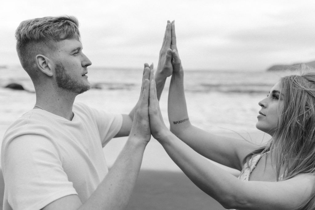 Couple posing for photo shoot couple ideas and prompts on beach in San Francisco California