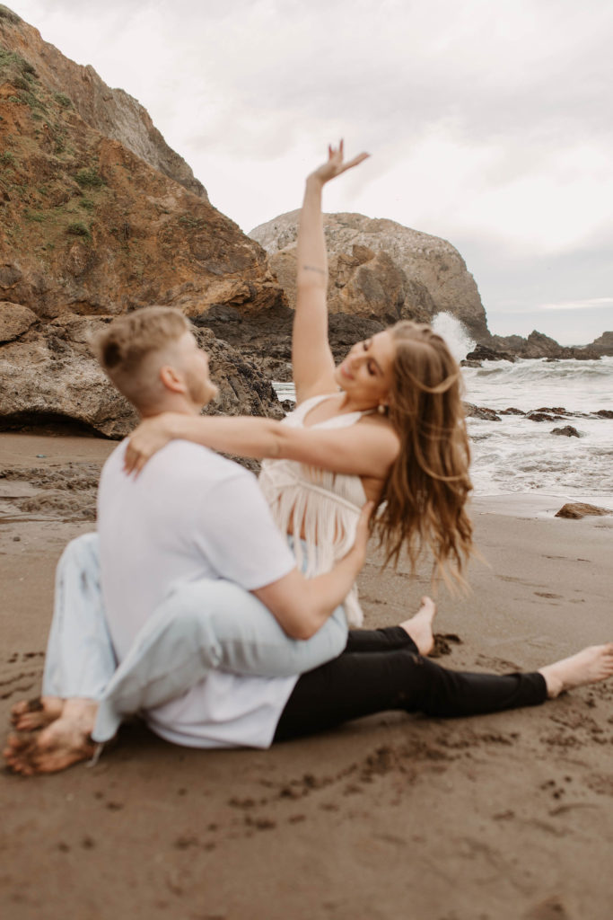 Couple posing for photo shoot couple ideas and prompts on beach in San Francisco California