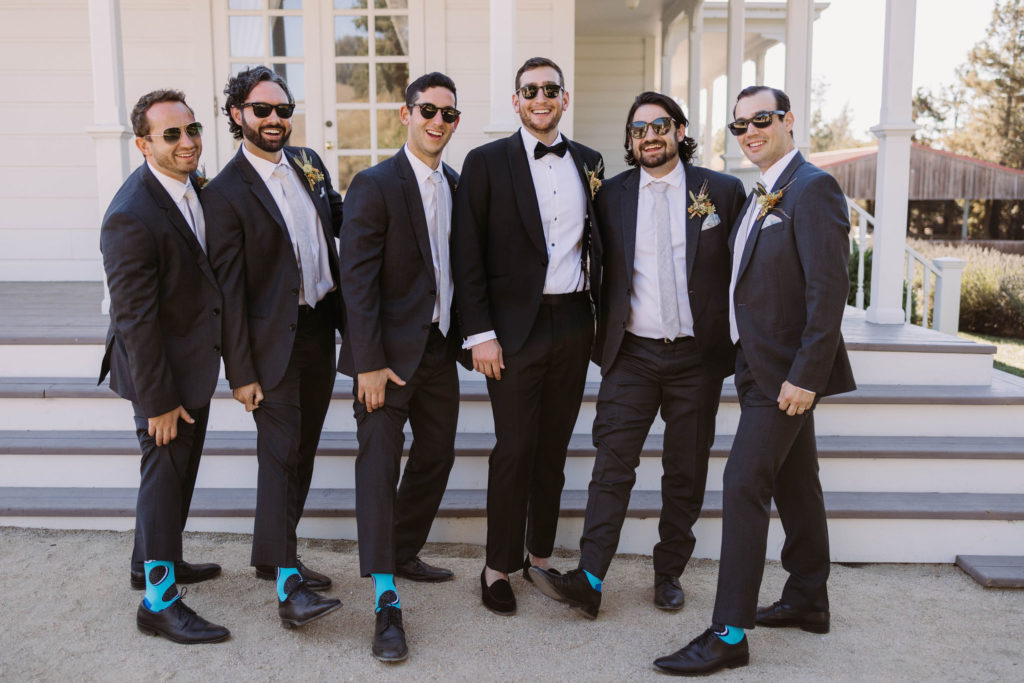 groom and groomsman showing off oreo wedding socks