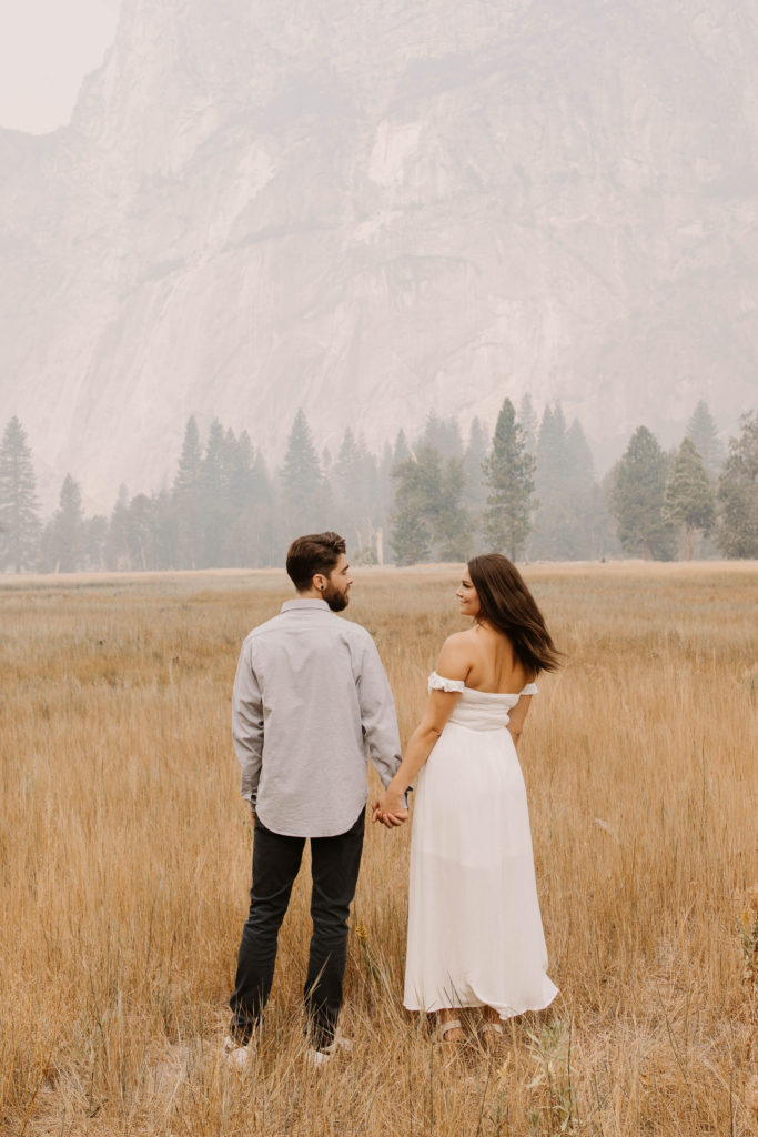 A couple posing for their September Yosemite anniversary photos