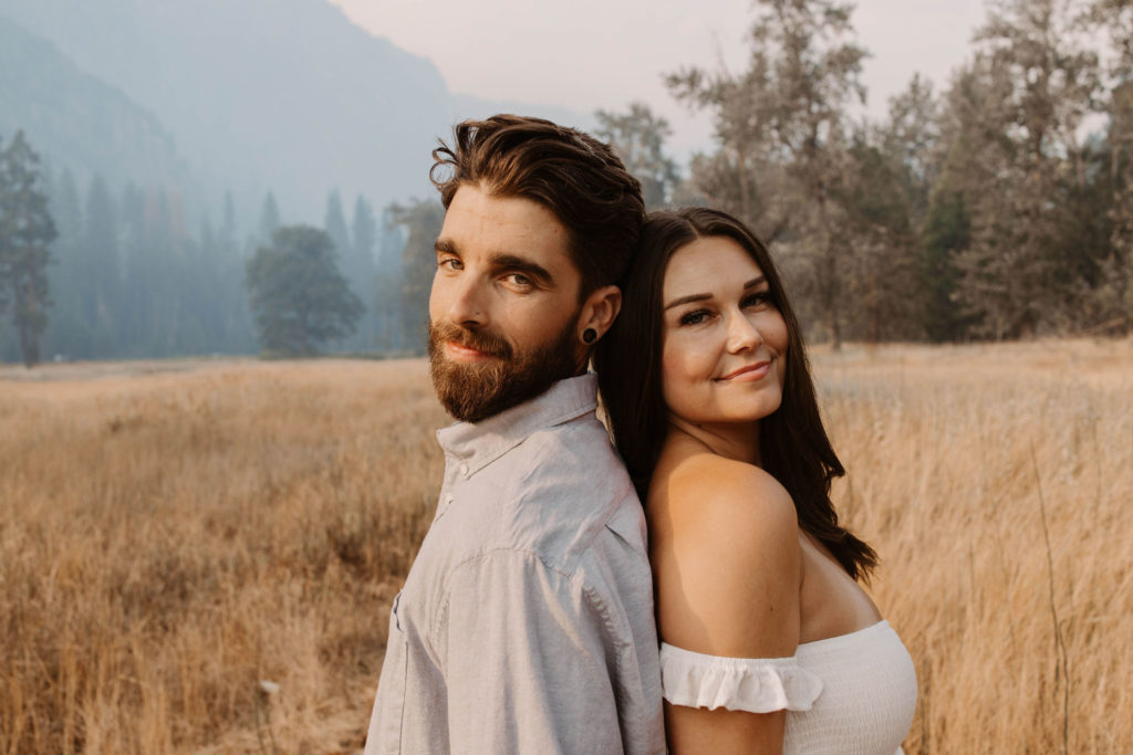 A couple posing for their September Yosemite anniversary photos