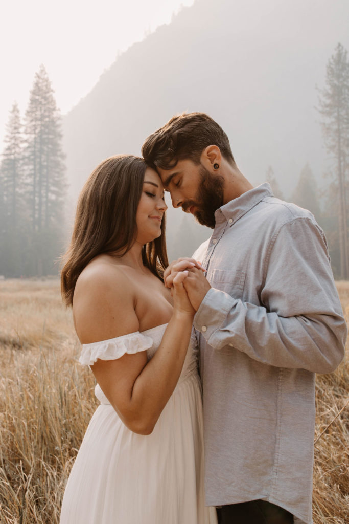 A couple posing for their September Yosemite anniversary photos