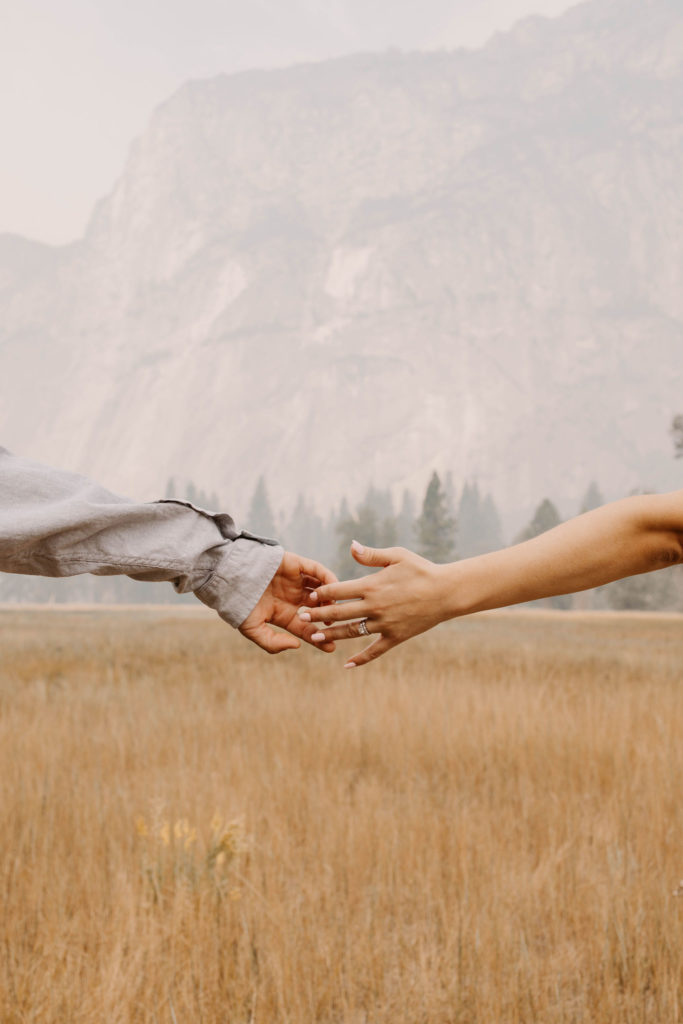 Couples hands reaching for eachother 