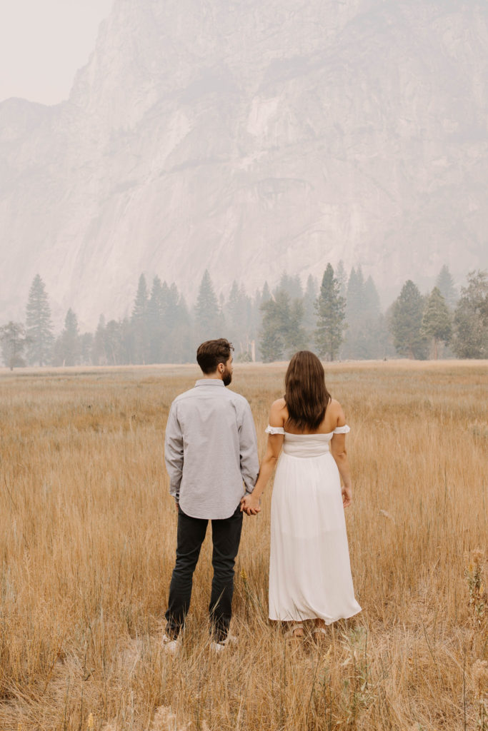 A couple posing for their September Yosemite anniversary photos