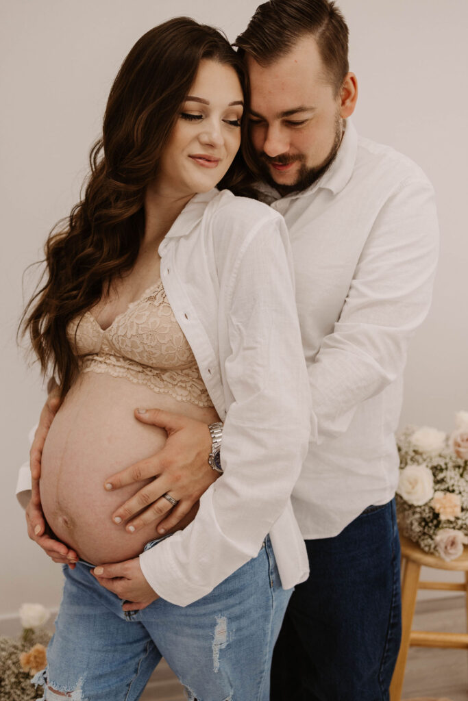 Man and pregnant woman posing for photoshoot