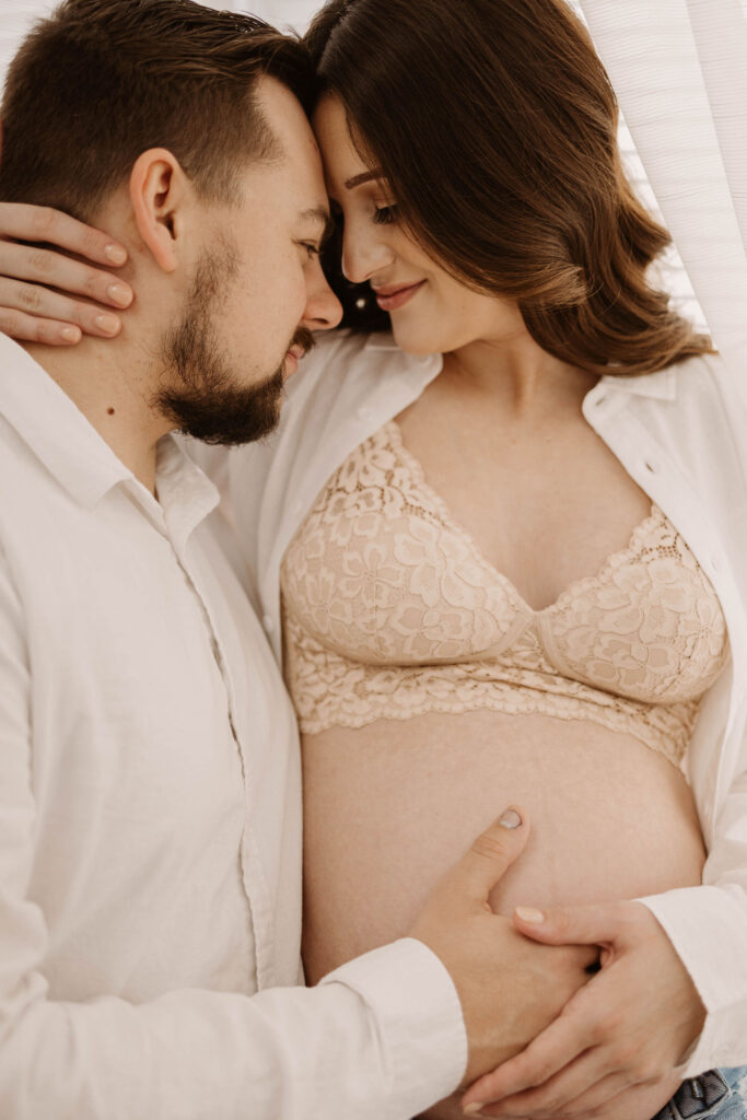 Man and pregnant woman posing for photoshoot