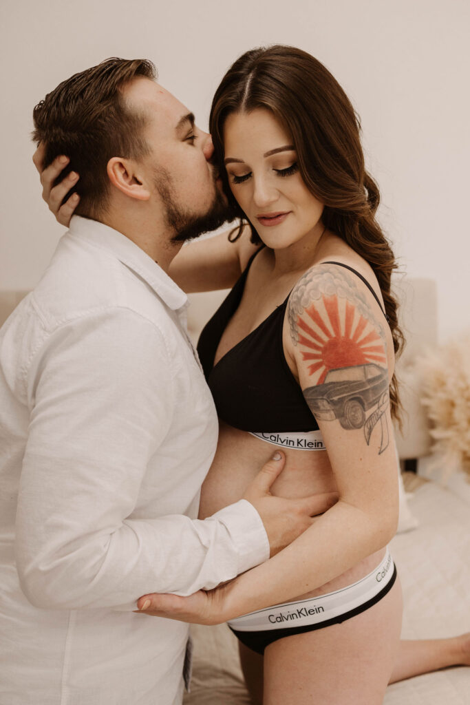 Man and pregnant woman posing for photoshoot