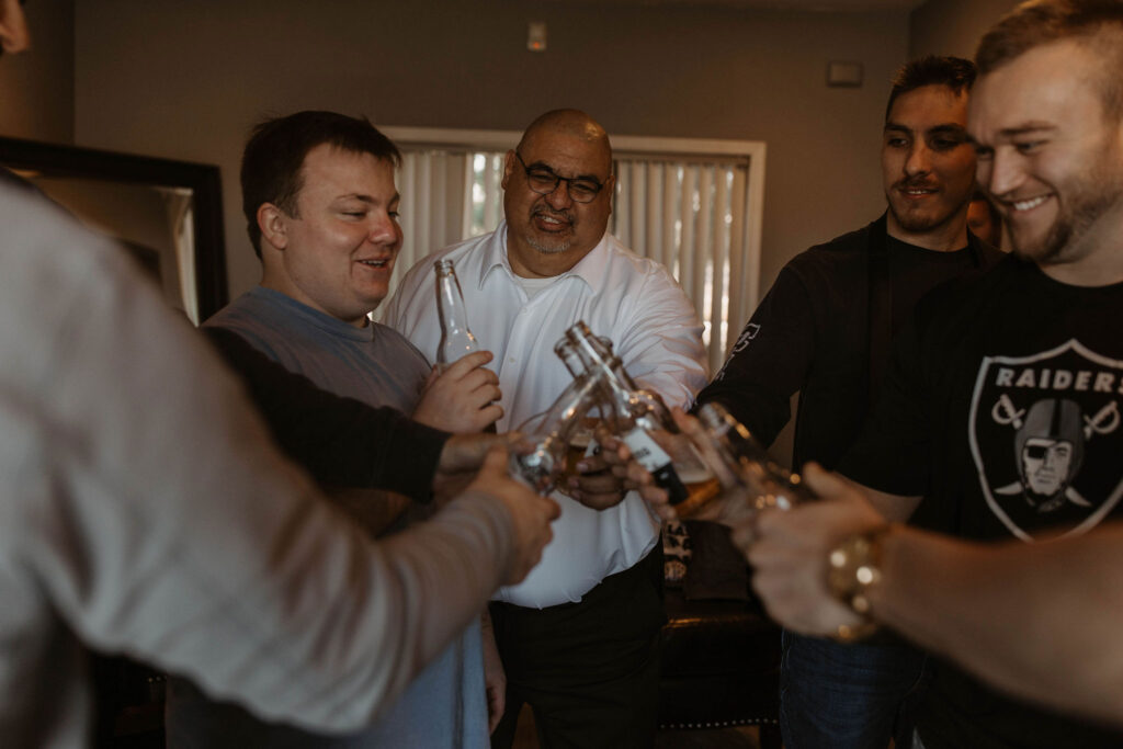 Groom and groomsman drinking before ceremony