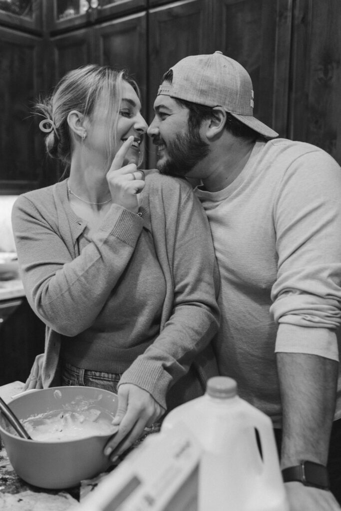 Couple making pancakes during in home couples session - Fun Couples Photoshoot Ideas