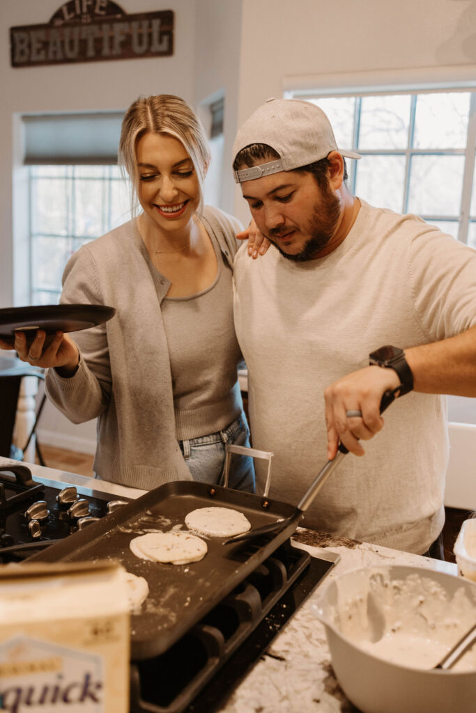 Couple making pancakes during in home couples session - Fun Couples Photoshoot Ideas