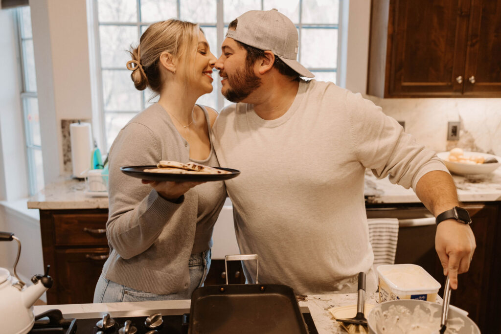 Couple making pancakes during in home couples session - Fun Couples Photoshoot Ideas