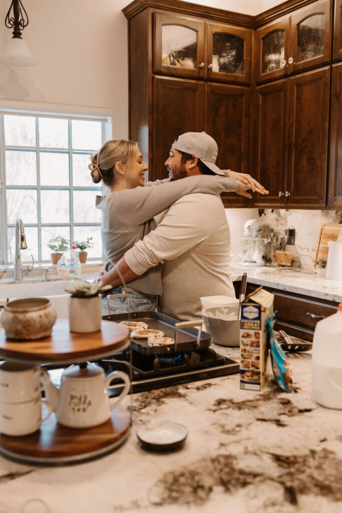 Couple making pancakes during in home couples session - Fun Couples Photoshoot Ideas