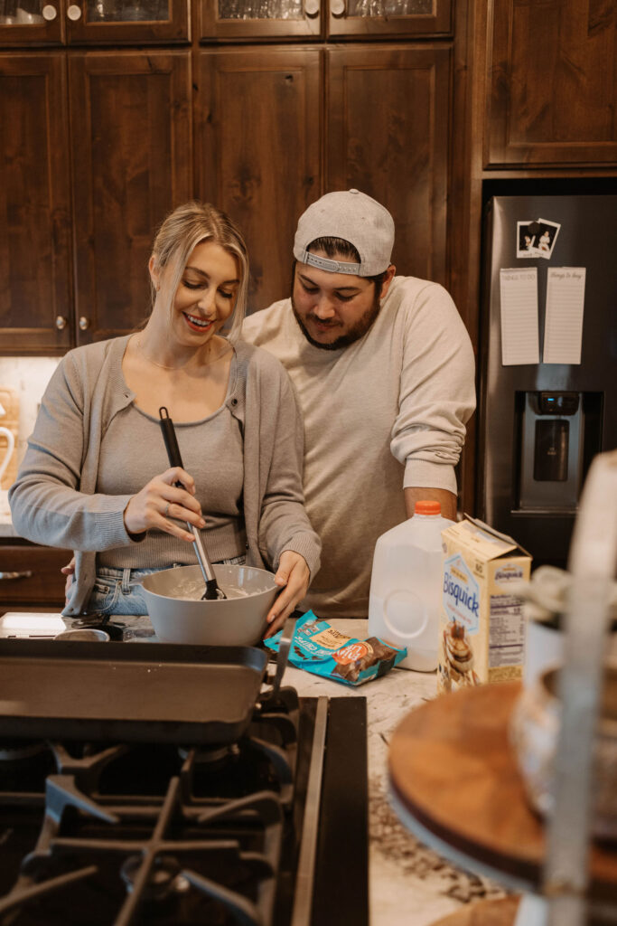 Couple making pancakes during in home couples session - Fun Couples Photoshoot Ideas