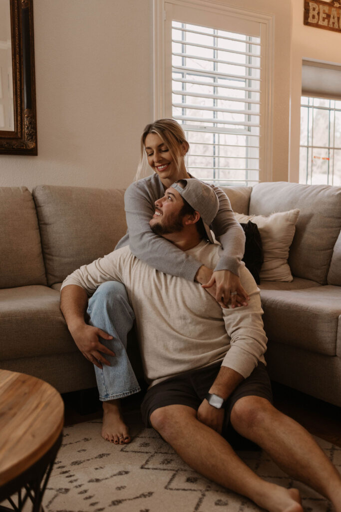 Couple sitting on their couch during photoshoot