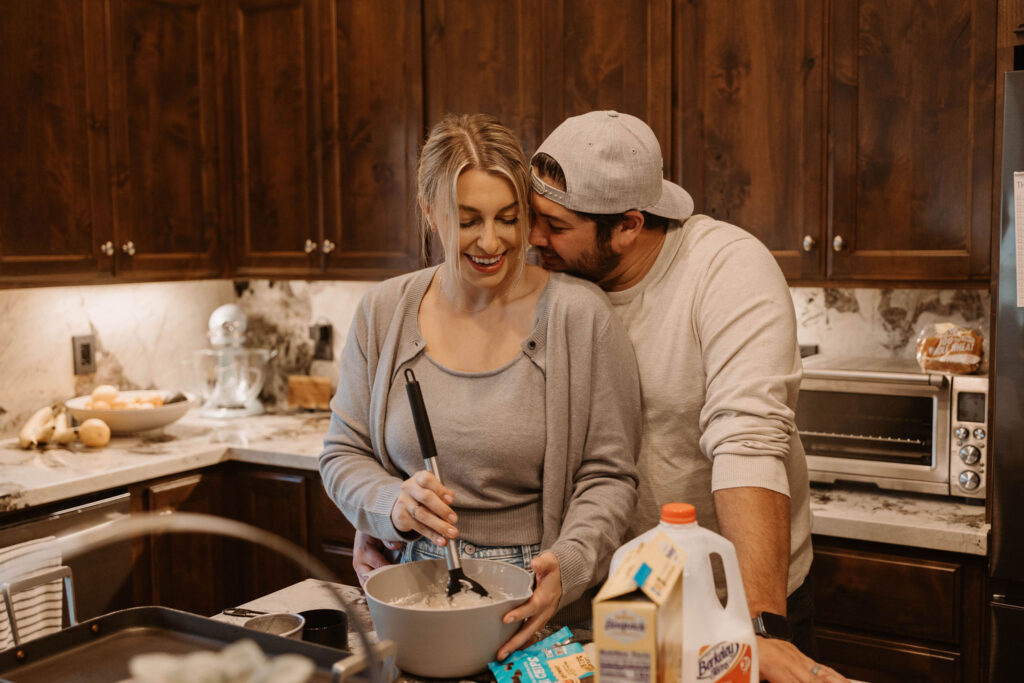 Couple making pancakes during in home couples session - Fun Couples Photoshoot Ideas